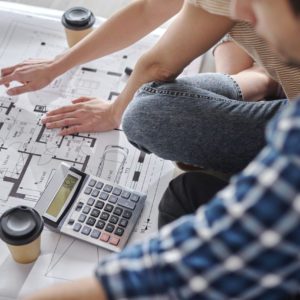 Close up of couple calculating costs of new house
